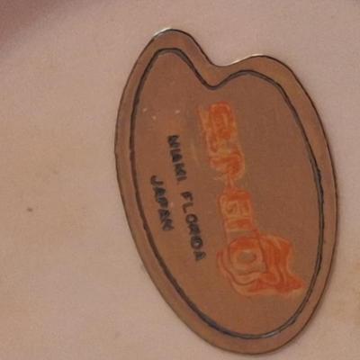 vintage Florida souvenir ceramic demitasse cup and saucer set featuring a pink flamingo and palm trees.