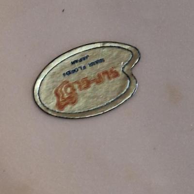 vintage Florida souvenir ceramic demitasse cup and saucer set featuring a pink flamingo and palm trees.