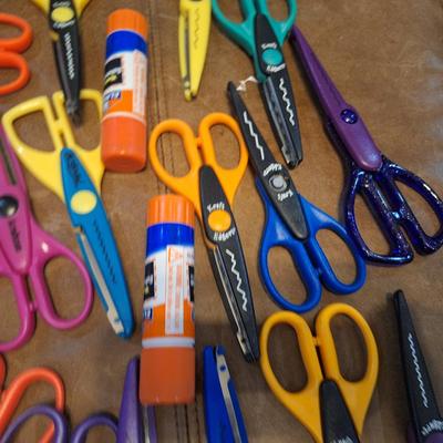 assortment of craft scissors, glue sticks and colored pencils