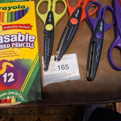 assortment of craft scissors, glue sticks and colored pencils