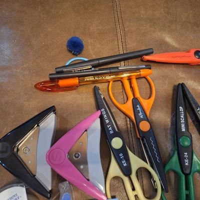 assortment of craft scissors, glue sticks and colored pencils