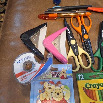 assortment of craft scissors, glue sticks and colored pencils