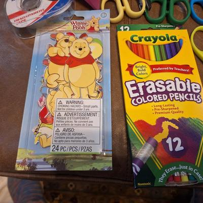 assortment of craft scissors, glue sticks and colored pencils
