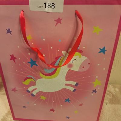 various dolls and toys, barbie, horse and other items all in a unicorn bagq