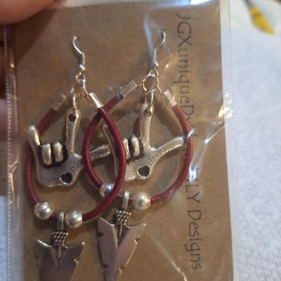 3 pieces of jewelry 2 which have the I love you sign language symbol