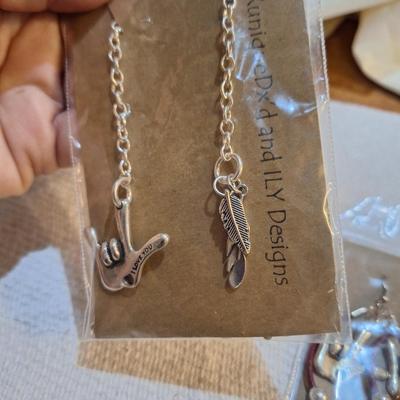 3 pieces of jewelry 2 which have the I love you sign language symbol