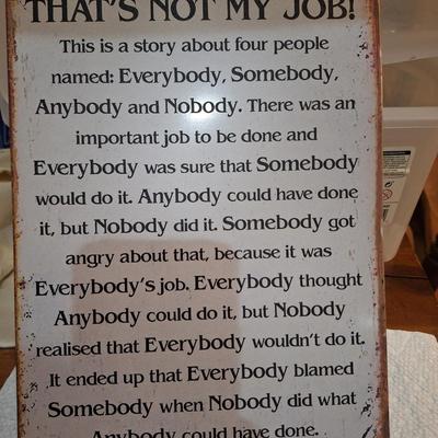 Metal sign with story about teamwork and responsibility.