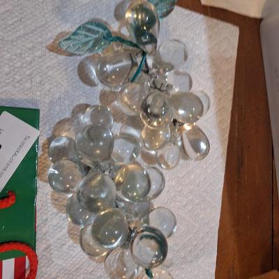 set of two vintage clusters of hand-blown clear glass grapes, one has green leaves one has clear.