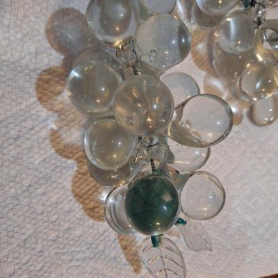 set of two vintage clusters of hand-blown clear glass grapes, one has green leaves one has clear.