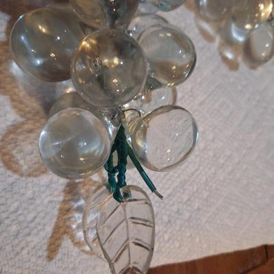 set of two vintage clusters of hand-blown clear glass grapes, one has green leaves one has clear.