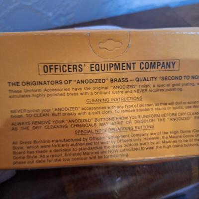 set of Officer's Equipment Company anodized gold buttons for a U.S. Marine Corps enlisted dress blue uniform