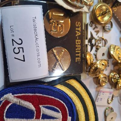 mixed lot of vintage and modern U.S. military uniform patches, pins, badges, and buttons