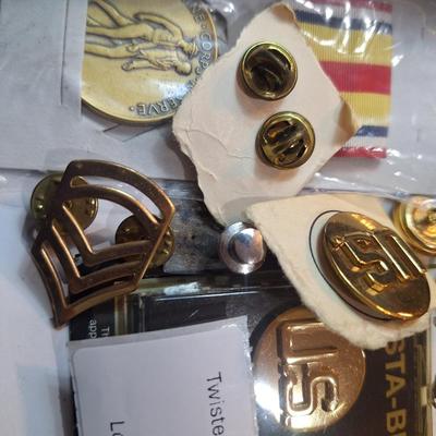 mixed lot of vintage and modern U.S. military uniform patches, pins, badges, and buttons