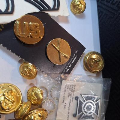 mixed lot of vintage and modern U.S. military uniform patches, pins, badges, and buttons