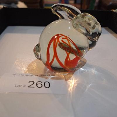 vintage, hand-blown art glass bunny rabbit paperweight with a red swirl design