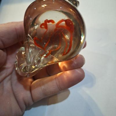 vintage, hand-blown art glass bunny rabbit paperweight with a red swirl design