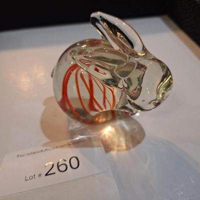 vintage, hand-blown art glass bunny rabbit paperweight with a red swirl design