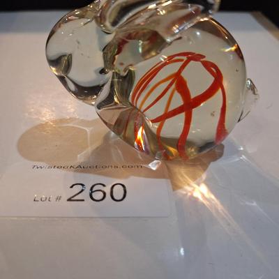 vintage, hand-blown art glass bunny rabbit paperweight with a red swirl design