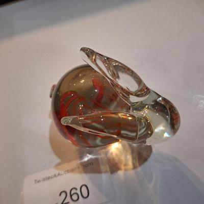 vintage, hand-blown art glass bunny rabbit paperweight with a red swirl design