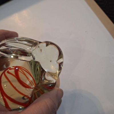 vintage, hand-blown art glass bunny rabbit paperweight with a red swirl design