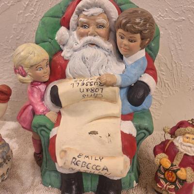 vintage ceramic Christmas figurine of Santa with two kids, and then two smaller Christmas items