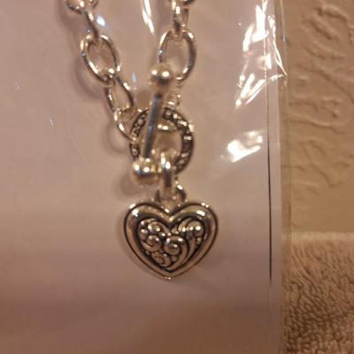 silver-tone chunky rolo chain toggle necklace with a heart pendant by the brand Icon.