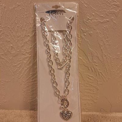 silver-tone chunky rolo chain toggle necklace with a heart pendant by the brand Icon.