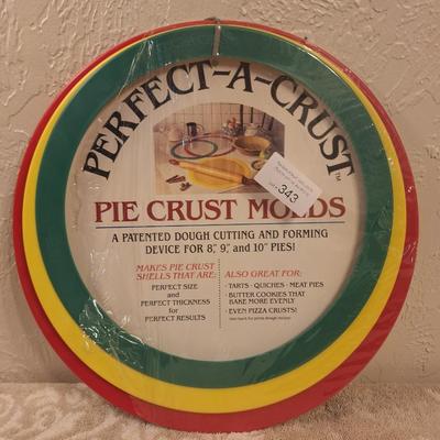 "Perfect-A-Crust" pie crust molds. The product is a patented dough cutting and forming device for 8, 9, and 10-inch pies