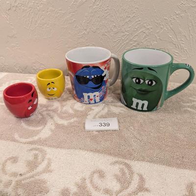 image shows a set of four M&M's character mugs and cups