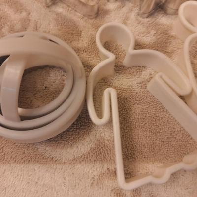 various cookie cutters, biscut cutters, measuring spoons and other