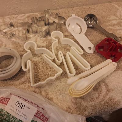 various cookie cutters, biscut cutters, measuring spoons and other