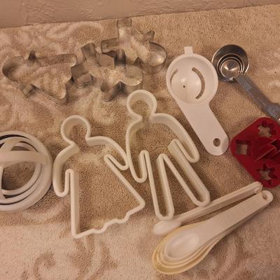 various cookie cutters, biscut cutters, measuring spoons and other
