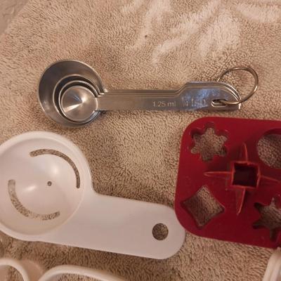 various cookie cutters, biscut cutters, measuring spoons and other