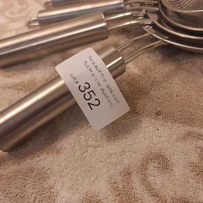 Set of stainless steel fin mesh strainers.