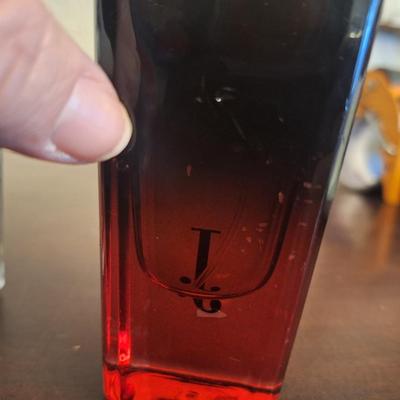  two bottles of fragrance products: Denim After Shave and Uroosa Eau de Parfum by Junaid Jamshed