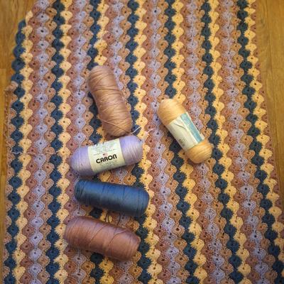unfinished crocheted blanket, and the yard to use to finish it.