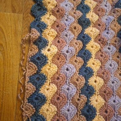 unfinished crocheted blanket, and the yard to use to finish it.