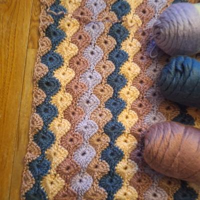 unfinished crocheted blanket, and the yard to use to finish it.