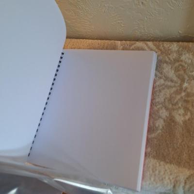 Sketchbook and a set of soft art pastels as well as some oil pastels.  The sketch book has one page with drawings on it.