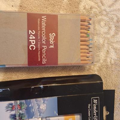 watercolor paints and pencils