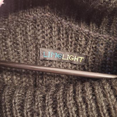  black cowl neck poncho sweater with pearl details.