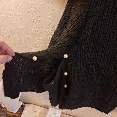  black cowl neck poncho sweater with pearl details.