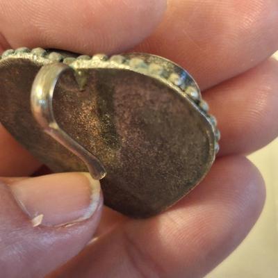 heart shaped pendant or scarf clip.  See photo of back it does not fully close, it slips over something.