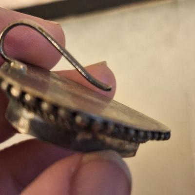 heart shaped pendant or scarf clip.  See photo of back it does not fully close, it slips over something.