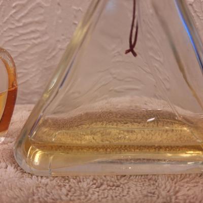 2 bottles of fragrance  1.  Lancôme Poême Eau de Parfum. And 2.  Lix Claiborn Triangle Eau De Toilette