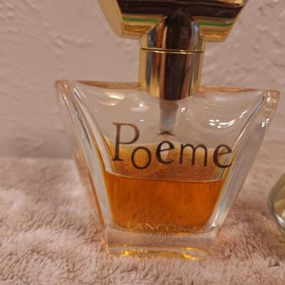 2 bottles of fragrance  1.  Lancôme Poême Eau de Parfum. And 2.  Lix Claiborn Triangle Eau De Toilette