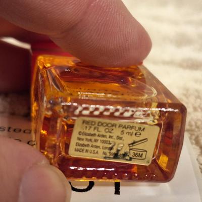 miniature bottle of Elizabeth Arden Red Door perfume.