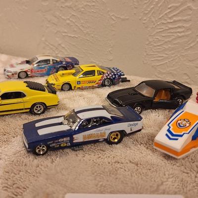 Hotwheels and other pocket size cars as well as a lego personal watercraft.