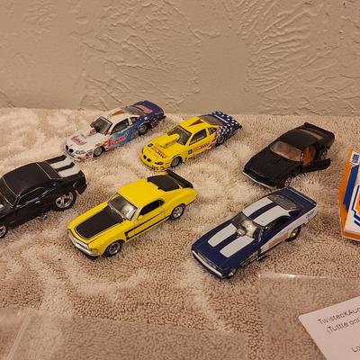 Hotwheels and other pocket size cars as well as a lego personal watercraft.