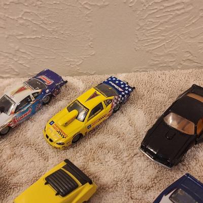 Hotwheels and other pocket size cars as well as a lego personal watercraft.